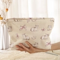 Beige corduroy storage bag with cute cat and bow prints held by hand in a cozy setting - Beige Cat Bow (CH210687)