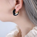 Elegant U-shaped hoop earrings featuring black enamel and gold finish on a female model - Black Enamel Gold C-Shaped Earrings