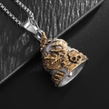 Colgante de campana de acero de titanio con calavera y detalles en oro antiguo - Campana Bicolor Oro y Plata