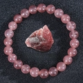 Detail of strawberry quartz elastic bracelet with raw crystal on black background - Strawberry Quartz