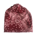 Close-up detail of red paisley pattern on knitted slouchy beanie with white floral motifs - Small Paisley Wine Red