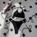 Women's black bikini set featuring bohemian shell chain accents and high-cut bottom - S / Black