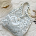 Détails de texture d'un sac cabas en velours bleu clair avec ours et fleurs - Bleu