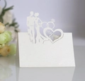 Macro detail of laser-cut Mr & Mrs heart pattern on white glittery pearlescent table card - Ivory