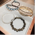 Selection of gold plated bracelets with opal pearls and heart charms on white tray - 5# Flower Round Bead Bracelet 5-Piece Set / Mixed Color 5-Piece Set