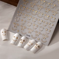 Macro detail of 3D gold embossed nail stickers with smiley faces and stars on white nails - Gold Funny Emoji Style (CO-340 Gold Stamping)