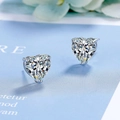 Elegant heart-cut zircon stud earrings in silver multi-prong setting on light blue card - White Zirconia