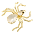 Golden spider pendant with clear crystal center and black gemstone eyes on white background - Spider / Gold