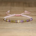 Close-up of pink and purple beaded bracelet with adjustable woven strap and gold metal spacers - No.67 Rose & Amethyst