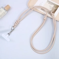 Close-up of beige leather phone lanyard with silver metal clasp and T-shaped spacer - Off-white