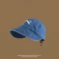 Blue denim sun visor hat with white bow embroidery and adjustable black drawstring - Empty Top Hat Bowknot Design / Dark Blue