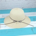 Detail of beige woven straw hat featuring a brown ribbon bow and white pearl pendant - M (56-58cm) / Beige