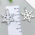 Silver and white snowflake pendants with ruler for size reference and DIY crafts - White K Snowflake 24x19mm