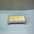 Rectangular metal jewelry display box with beige velvet ring slots and gold ornate legs - Ring Display Box