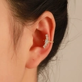 Detailed view of a gold-plated multi-layer ear cuff featuring five sparkling white zircons - Gold with Zirconia