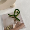 Macro shot of large dark green acetate shark hair claw with durable gold metal spring - Glazed Green - Gold Clip