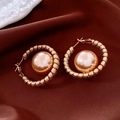 Detail of 18K gold plated horse-shaped earring with champagne pearl on silk background - Gold Champagne Hoop Pearl Earrings