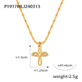 Macro detail of 18K gold-plated cross pendant with heart center and pavé zircon stones - Wings Cross Pendant / Gold Heart Wings
