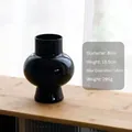 Minimalist black glossy glass vase with round body and stable base for art decoration - Black