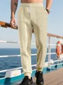 Dettaglio dei pantaloni jogger beige da uomo con coulisse e texture a nido d'ape a rombi - Taglia S / Pantaloni e gonne / Kaki