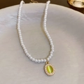 Vintage style pearl necklace featuring a oval cat-eye stone pendant in golden frame - Gold Cat Eye Stone Oval Pearl Necklace