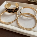 Detail of a leopard print cuff and gold bangles set displayed on a textile jewelry tray - 28# Leopard Style (HB4501)