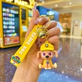 Detail of yellow Paw Patrol Rubble keychain with silicone strap and golden bell charm - Paw Patrol Rubble (Yellow) / Soft Rubber Style - 1 Piece