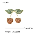 Fashionable cherry brooch with red and green cubic zirconia in a gold setting - Red