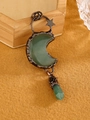 Close-up of vintage bronze moon pendant with green aventurine crystal and star charms - Aventurine Jade