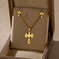 Close-up of golden stainless steel necklace and earring set in a premium jewelry gift box - Abstract Cross (TZ-459)