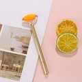 Creative orange textured roller decompression pen with golden metal grip for massage - Gold