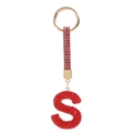Detailed macro view of red crystal letter S keychain with gold metallic hardware - Red