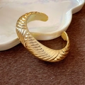 Irregular golden cuff bracelet featuring a textured wave pattern and metallic finish - Stripe Style / Gold