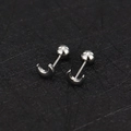 Macro view of silver stainless steel crescent moon cartilage earrings with screw back ball - Polished Moon / Steel