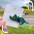Macro view of a dark green acetate cat hair clip with elegant marble texture and gold lines - Starry Green