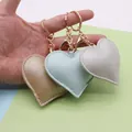 Three PU leather heart keychains in gold, mint green, and silver with golden hardware - Gold Chain Clasp / Mint Green