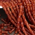 Macro shot of red agate bamboo-shaped beads for DIY jewelry making and necklaces - 6x12mm Agate Red (1Pc)