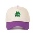 Detailed embroidery of a green clover with lucky text on a two-tone trucker cap - Adjustable / Cream/Purple