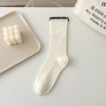 Cream white mid-calf cotton socks with black ruffled lace trim and ribbed texture - One Size / Cream