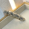Glossy silver spring hair clip with five linked hearts on a cream velvet display box - Heart Silver