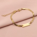 Detail of gold snake chain bracelet with polished engravable bar on silk background - 18K Gold Plated / Gold