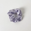 Detail view of light purple satin scrunchie with smooth silk-like texture and soft pleats - Without Card / Light Purple