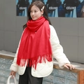 Elegant red wool cashmere scarf with fringe, shown worn on a white quilted jacket - Plush Style / 200x70cm / Red