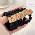 Elastic black hair tie with brown rabbit leather patch and soft fuzzy texture - Knit With Rabbit Tag / Black Rabbit