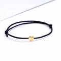 Minimalist adjustable black woven cord bracelet with a polished gold heart charm - Black/Gold