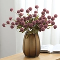 Artificial purple globe mum bouquet in textured brown glass vase on wooden table - Deep Purple