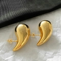 Detailed macro view of high-polished golden bean stud earrings on a textured background - Medium (3.3*1.8) / Gold