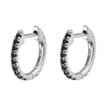 Close-up of 14K white gold huggie hoop earrings with micro-pave black gemstones - Silver Black Stone