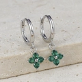 Close-up of S925 silver clover earrings with deep emerald green zircon stones on stone - Silver-Green
