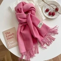 Pink cashmere feel scarf with fringe tassels displayed on a table with lifestyle props - Raspberry Pink